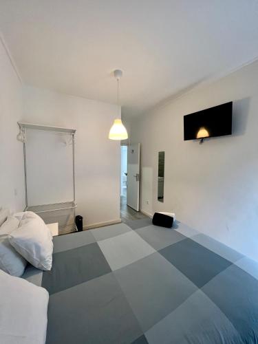 a bedroom with a blue and white checkered floor at Moreira Family in Porto