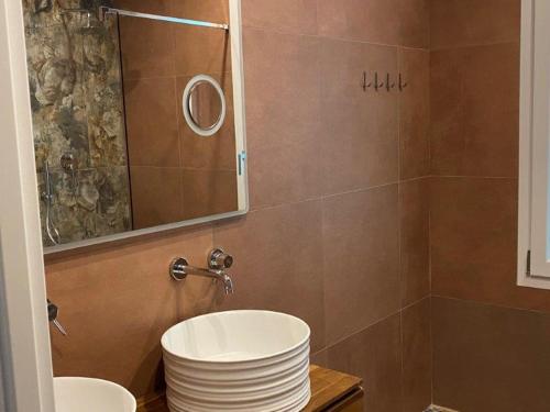 a bathroom with a sink and a mirror at Luxury 4 Apartaments Cervia with Swimming Pool in Cervia