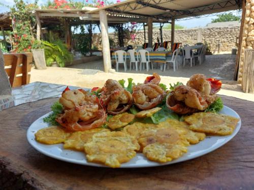 a plate of food with shrimp on a table at Del Mar Vendra in Manaure Viejo