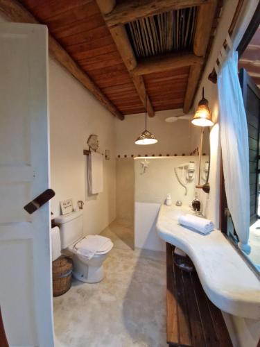 uma casa de banho com um lavatório e um WC em Mini Casa com Jacuzzi e Piscina em Trancoso