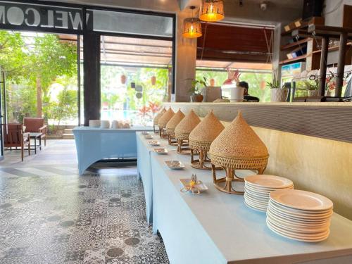 a line of plates on a counter in a restaurant at Kampot Sweet Boutique in Kampot