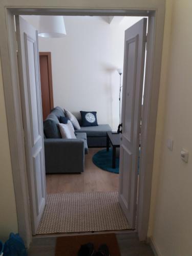 an open door into a living room with a couch at Lightoasis Oeiras 5 in Oeiras