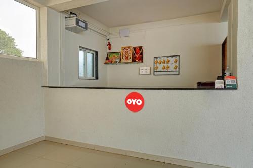 a counter in a room with a msg sign on the wall at Flagship 81482B Happy Homely Stay in Pune
