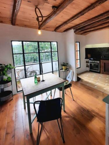a dining room with a table and chairs in a room at Casa Malva - Traditional townhouse apartment in Monchique