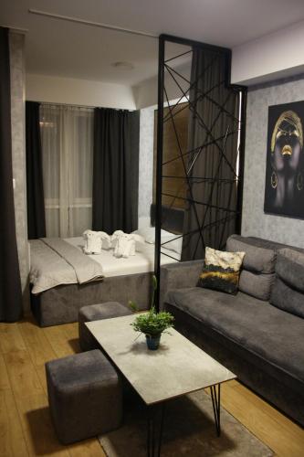 uma sala de estar com uma cama e um sofá em Luxury Apartment Skopje em Skopje