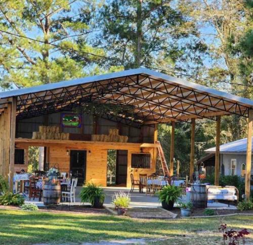 a pavilion with tables and chairs in a yard at Lazy Dog Acres 