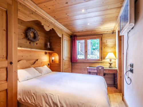 a bedroom with a bed in a wooden cabin at Chalet Morzine, 7 pièces, 14 personnes - FR-1-754-8 in Morzine