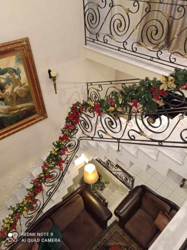 a staircase with a chair and christmas decorations on it at Three Goods Trikala Meteora in Tríkala