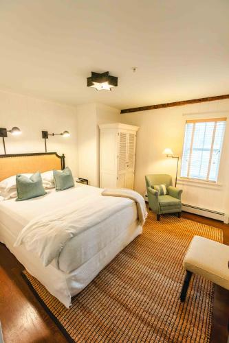 a bedroom with a large bed and a chair at Hill Farm Inn - Manchester in Sunderland