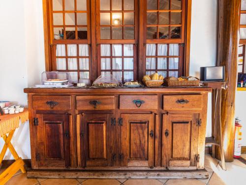 an old wooden cabinet with some food on it at Pousada Laguna Blue in Paraty