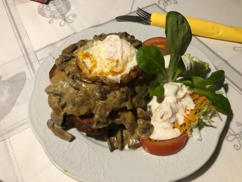 a plate of food with meat and vegetables on a table at Hotel-Restaurant Denklinger-Hof in Reichshof 