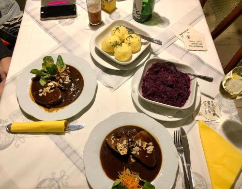 a white table with plates of food on it at Hotel-Restaurant Denklinger-Hof in Reichshof 