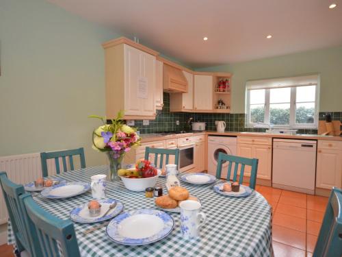 a kitchen with a table with plates of food on it at 3 bed in Minehead TRINI in Minehead
