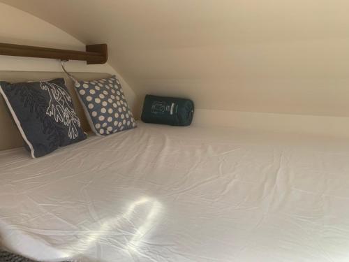 a white bed with two pillows on top of it at Andalusian Lifestyle in Marbella