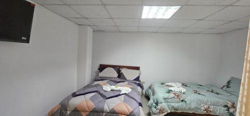 Łóżko lub łóżka w pokoju w obiekcie HOTEL TICLIO