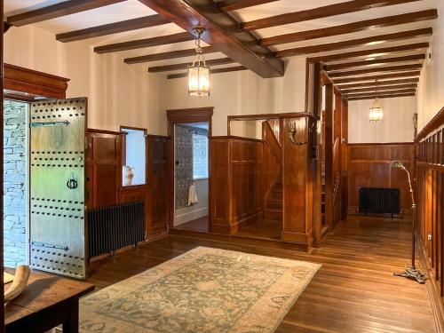 a large room with wooden walls and wooden flooring and a room with a shower at Daweswood, Patterdale in Patterdale