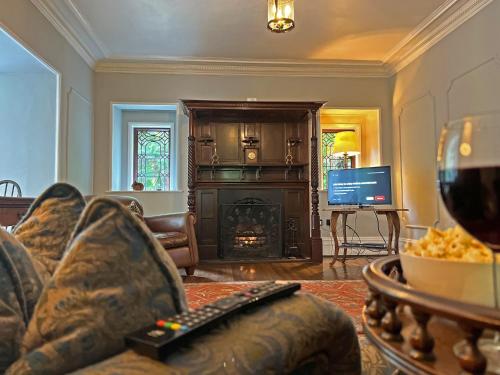 a living room with a couch and a fire place at Daweswood, Patterdale in Patterdale