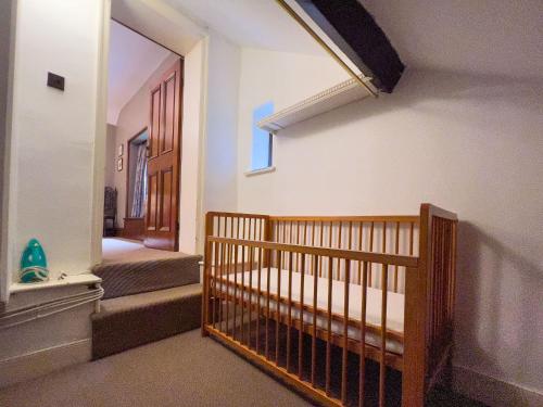 a baby crib in a room with a hallway at Daweswood, Patterdale in Patterdale