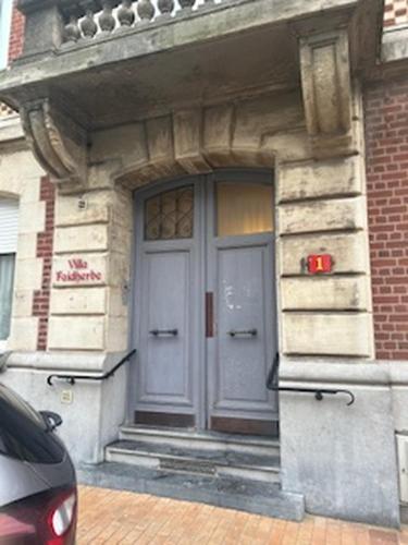 a front door of a building with two doors at Chambres d'hotes Villa Faidherbe B&B in Dunkerque