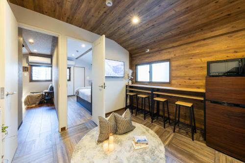 a living room with a tv and a bedroom at 2024年1月開業トレインビューホテル梅田 in Osaka