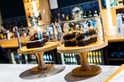 two glass containers filled with brownies on a table at The Dormy House in Tenby