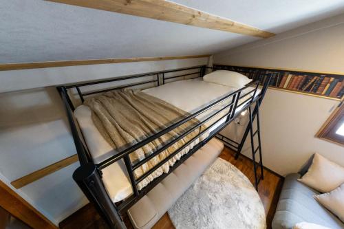 a bunk bed in a small room with a couch at 2024年1月開業トレインビューホテル梅田 in Osaka