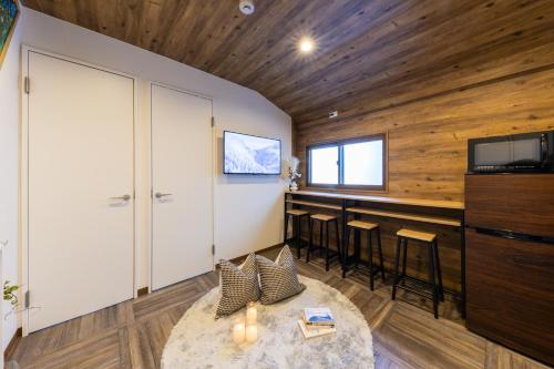 a living room with a bar and a tv at 2024年1月開業トレインビューホテル梅田 in Osaka