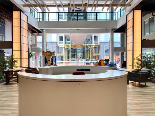 a lobby of a building with a circular counter at HillMark Suites in Ayer Keroh