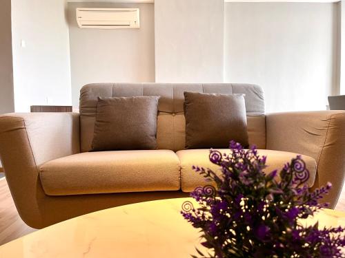 a living room with a couch and a table at HillMark Suites in Ayer Keroh