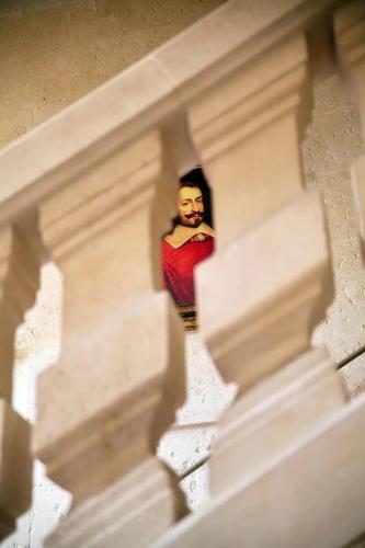a model of a man walking down a stairs at La Villa Mazarin in Aigues-Mortes