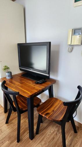 a television sitting on a wooden table with a chair at Kiman09 in Seoul
