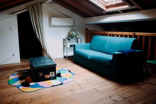 a living room with a blue couch and a table at Maison Typique Landaise in Moliets-et-Maa