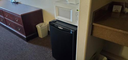 a microwave sitting on top of a small refrigerator at Days Inn by Wyndham Beaver in Beaver
