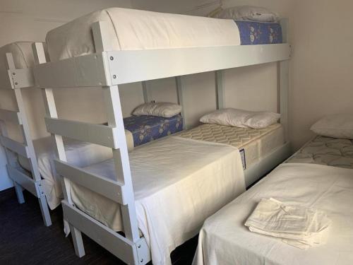 two bunk beds in a room with two beds at Barcelona Hostel in Mar del Plata