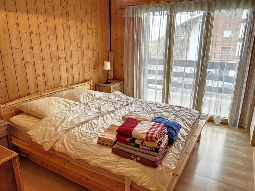 a bedroom with a bed with towels on it at Tzoumaz Mountain Retreat in La Tzoumaz