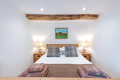 ein Schlafzimmer mit einem Bett mit zwei Nachttischen in der Unterkunft ryton grange hay barn sleeps 6 in Shrewsbury