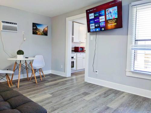 a living room with a tv on the wall at Elegant 1 Bed Montrose - Rome @The Italian Plaza in Houston