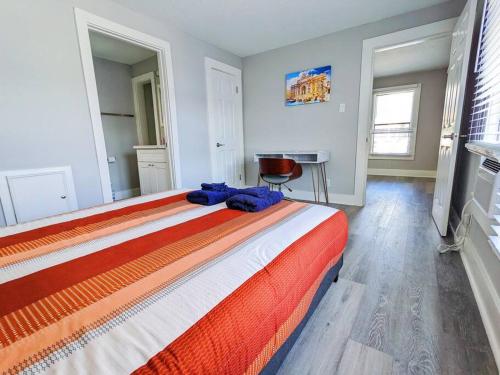 a bedroom with a large bed in a room with a desk at Elegant 1 Bed Montrose - Rome @The Italian Plaza in Houston