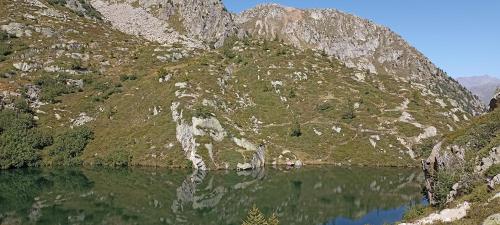 a mountain reflecting in the water of a lake at NEW ENTRY - Nuova villa nel verde in Mezzana