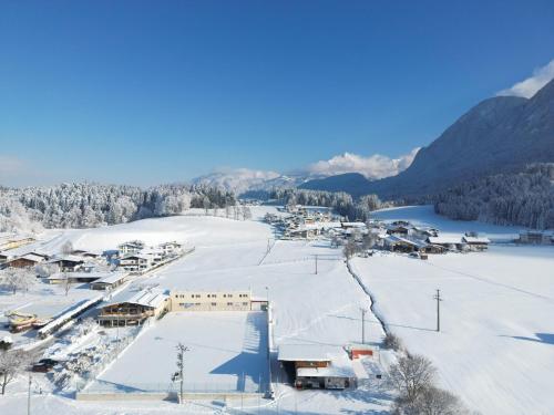 a small town in the snow with a lake at Natur Residenz Bad Häring in Bad Häring