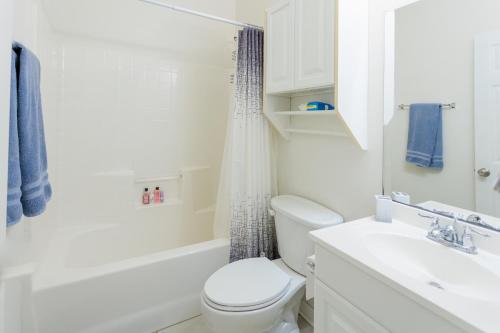 a white bathroom with a toilet and a sink at Private 2 bedroom and 2 bathroom in Savannah in Savannah