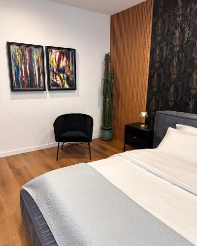 a hotel room with a bed and a chair at Residenza Ricci & Spa in Foggia