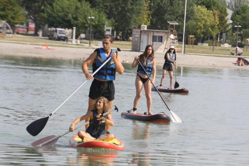 a group of people on paddle boards in the water at Provence, Studio climatisé, vue lac Spirou 400 metres, Avignon 15 mn in Monteux