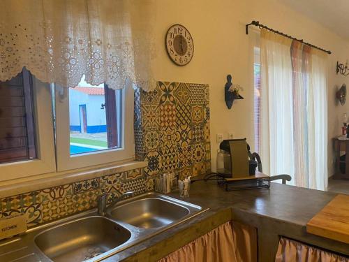 a kitchen with a sink and a window at Ferroa Guest House in Cano