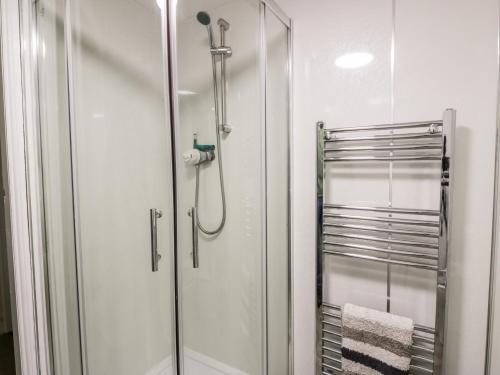 a shower with a glass door in a bathroom at Sea Spray in Eyemouth