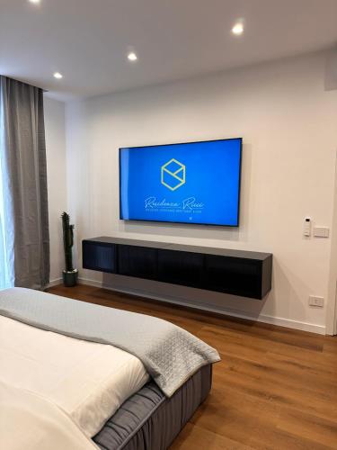 a bedroom with a flat screen tv on a wall at Residenza Ricci & Spa in Foggia