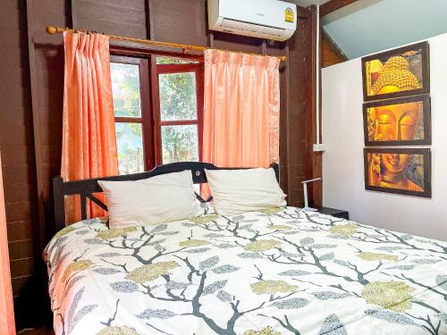 a bedroom with a bed and a window at Koh Yao Noi Garden Home in Ban Nai Khlong