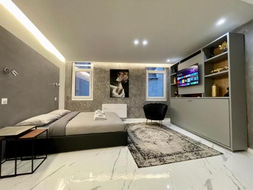 a bedroom with a bed and a television in it at TALEDA Apartments - Modern Apartments & Self Checkin in the Old Town in Lugano