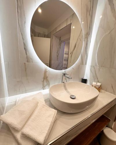 a white bathroom with a sink and a mirror at Residenza Ricci & Spa in Foggia