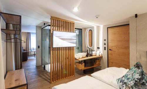 a bathroom with a sink and a desk in a room at Glanz & Glory Appartements Sölden in Sölden